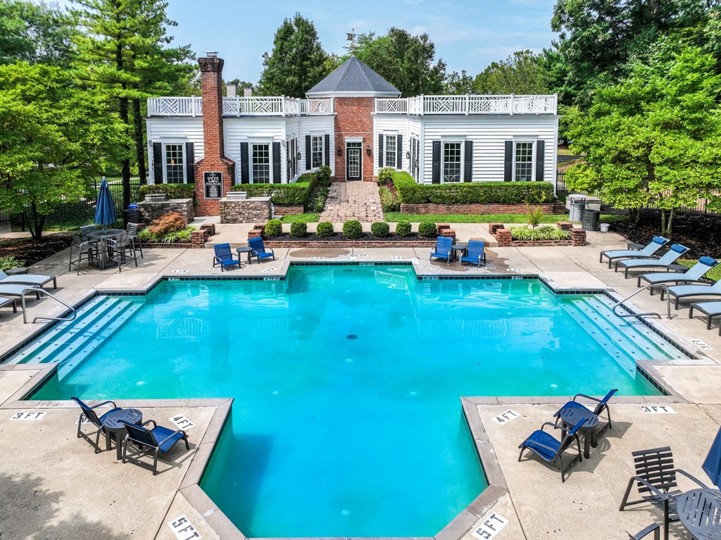 a swimming pool with chaise lounge chairs