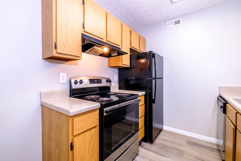 a kitchen with wooden cabinets