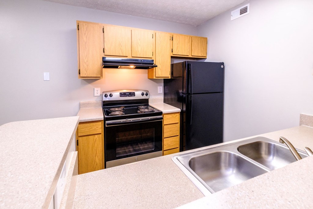 a kitchen with wooden cabinets