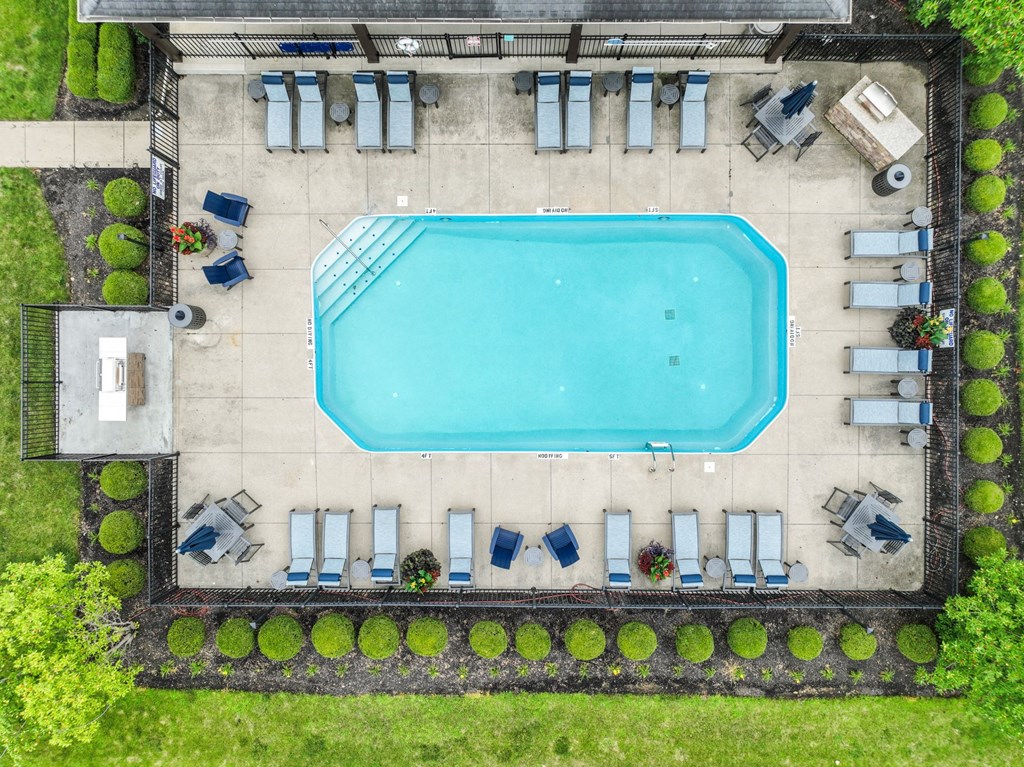 arial view of a swimming pool with lounge chairs