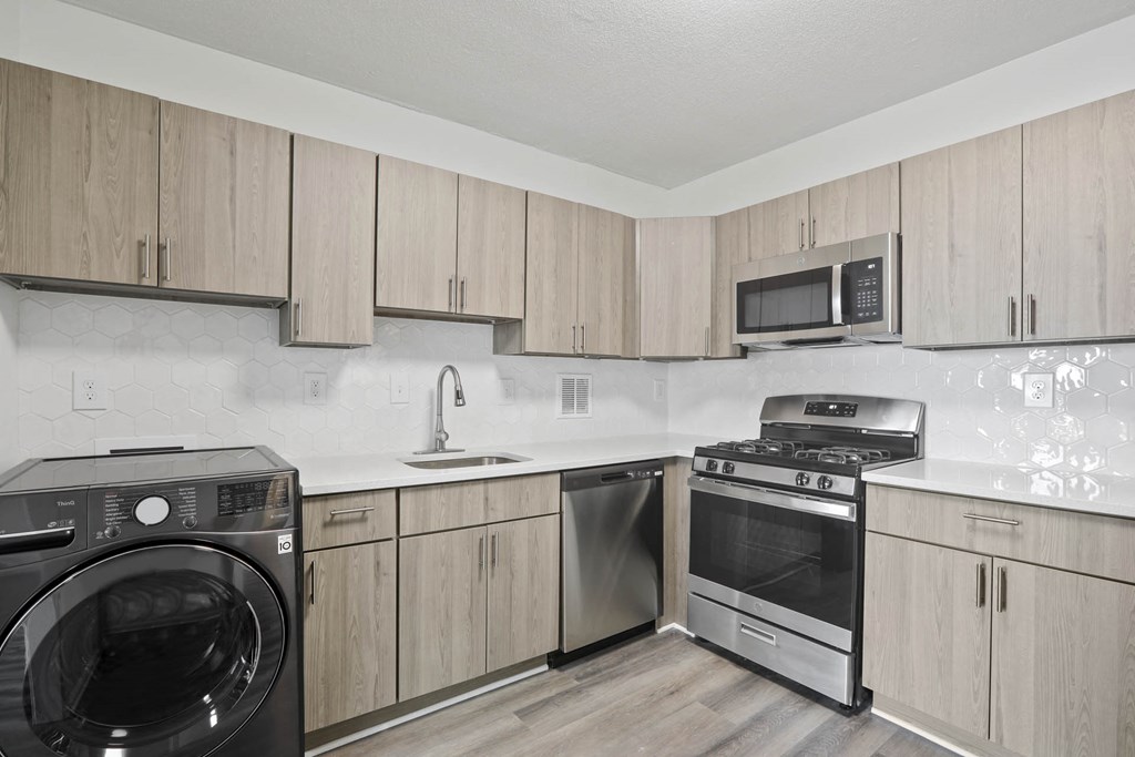 Skyline Towers apartments kitchen with wood cabinets and stainless kitchen appliances