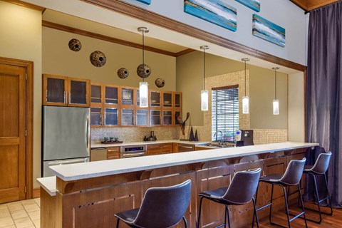 a kitchen with a counter top and chairs