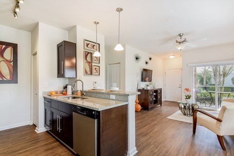 A kitchen with a black fridge and a white counter top.