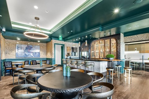 A modern restaurant with a large table in the center of the room.