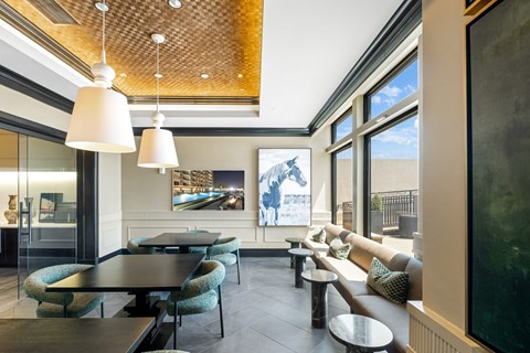 A modern dining room with a glass table and chairs.