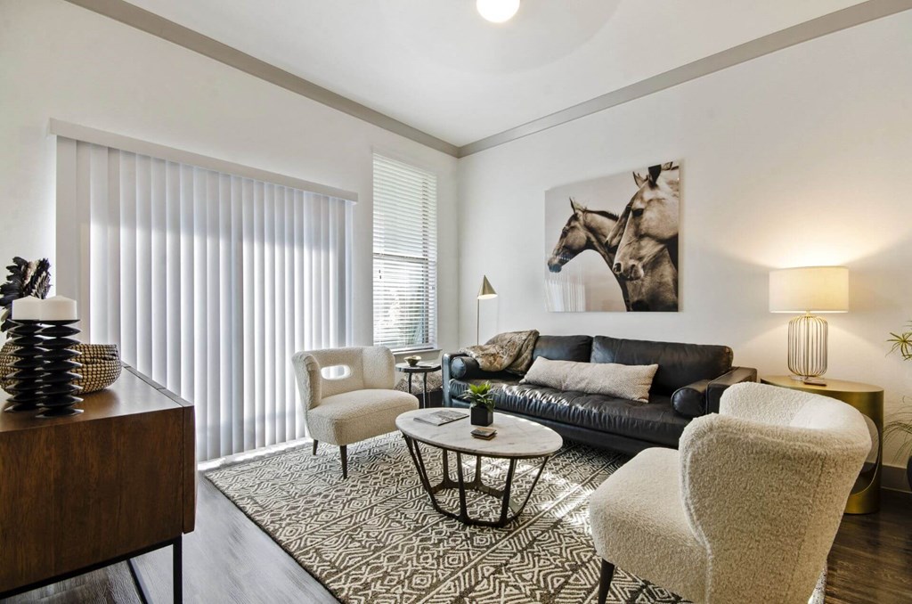 Living room with sofa and wall frame at Reveal at Bayside, Texas