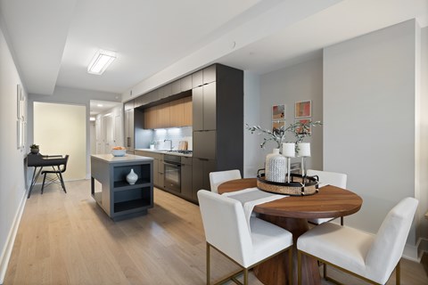 A modern kitchen with a dining table and chairs.