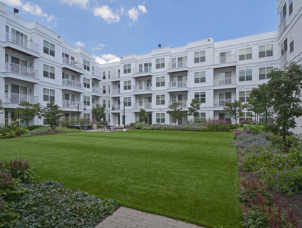 Interior building courtyard with lush grass lawn surrounded by building