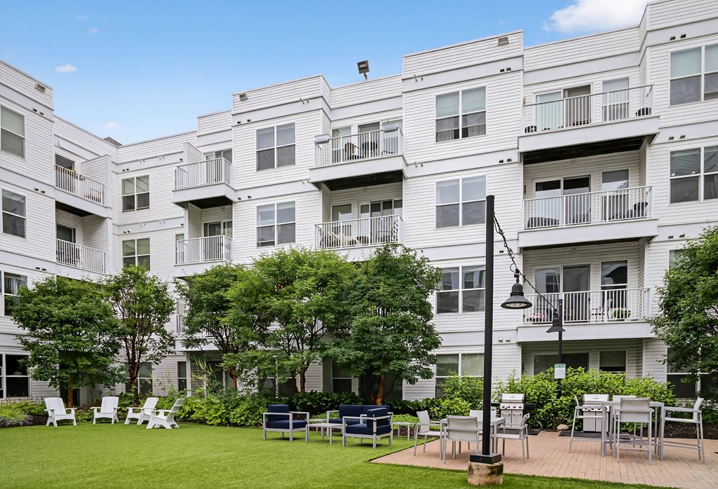 Apartment complex with a grassy area in front.