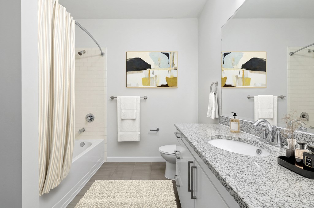 a bathroom with a sink and a shower and a toilet