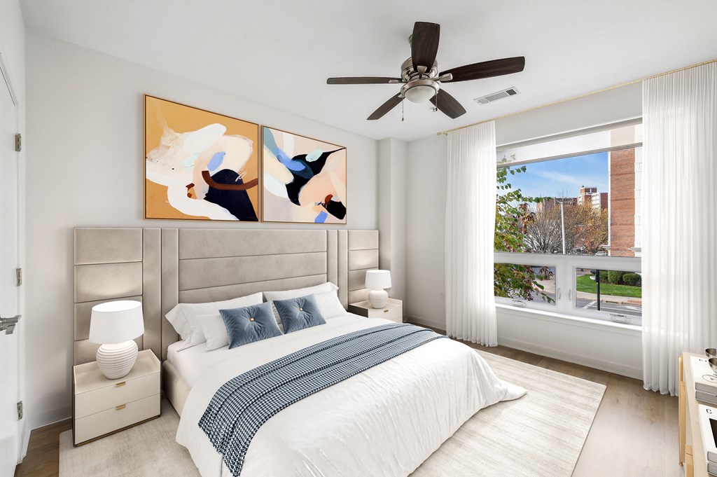 a bedroom with a bed and a ceiling fan
