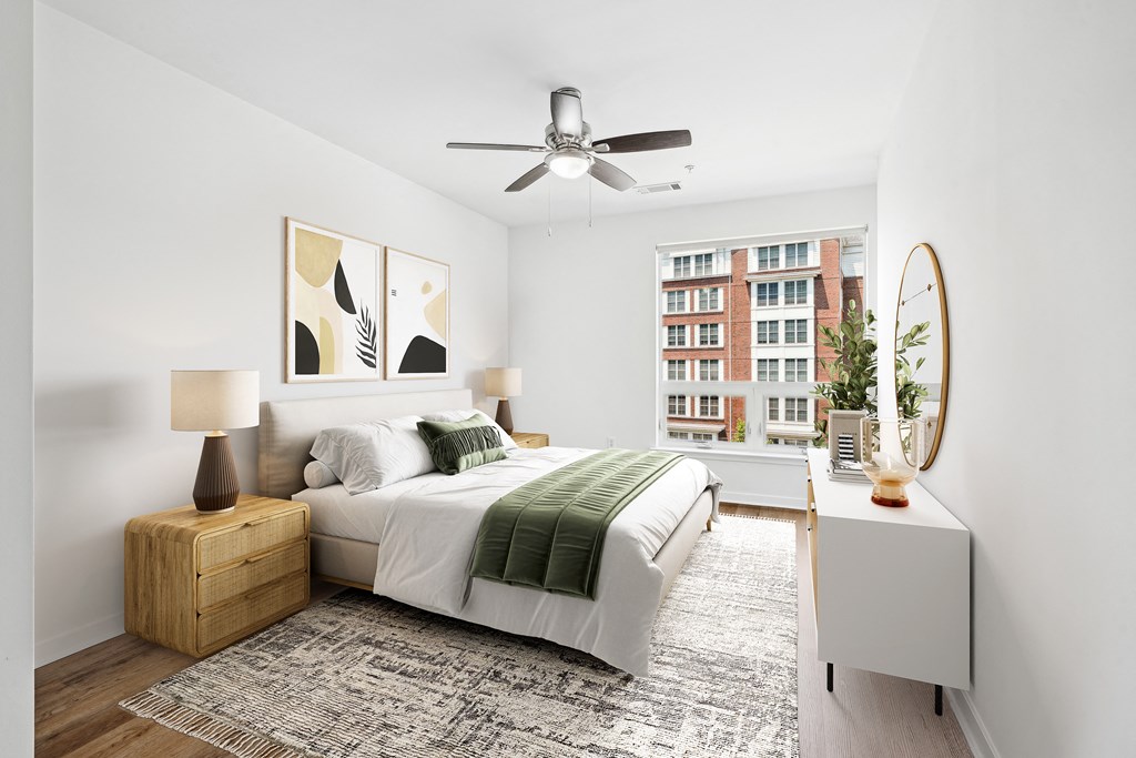 a bedroom with a large bed and a ceiling fan