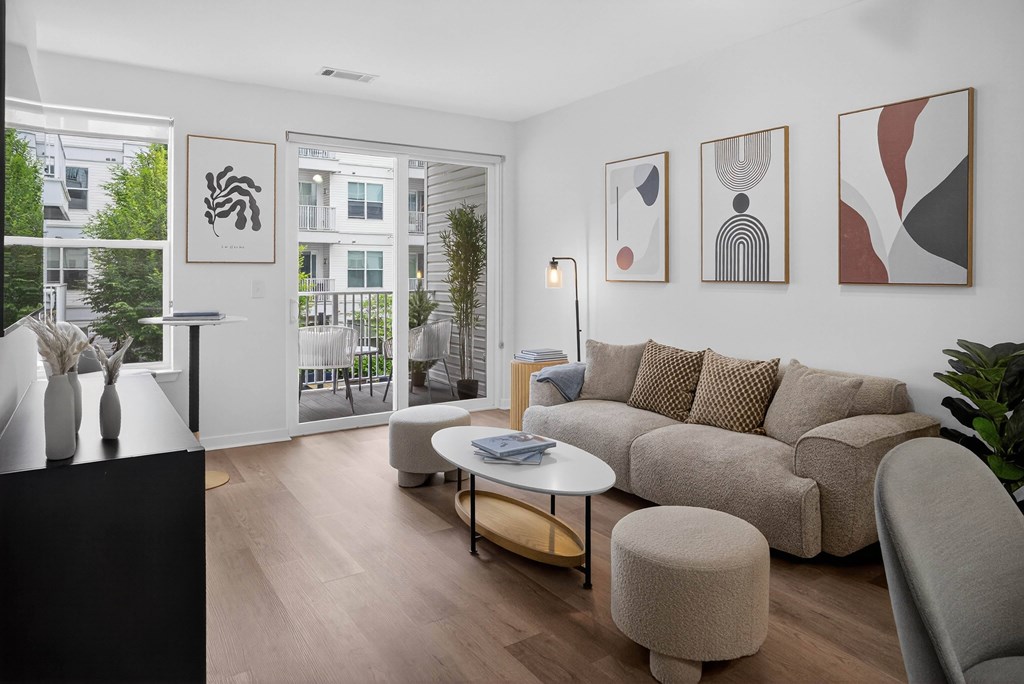 A living room with a couch, a table, and a plant.