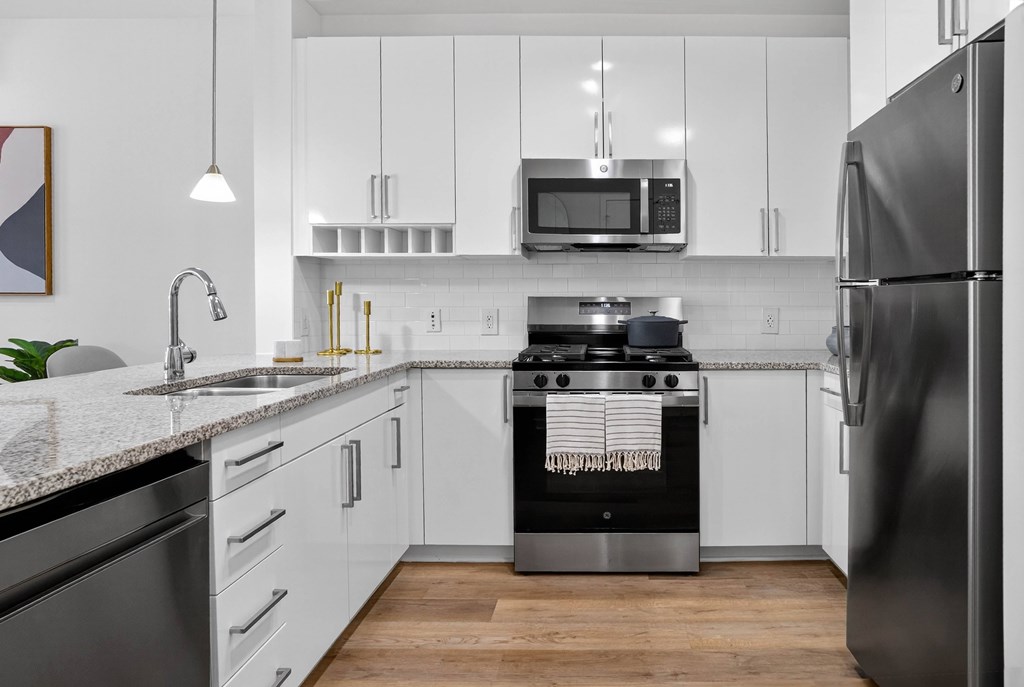 A modern kitchen with a black stove top oven.