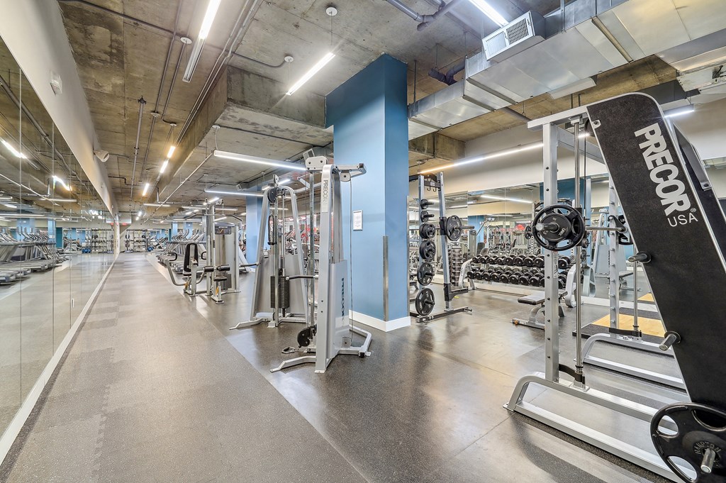 a gym with weights and a skateboard in it