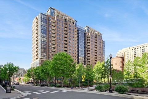 A tall building with a lot of windows is in the background.