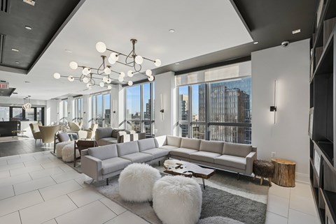 A modern living room with a large grey sofa and a coffee table.
