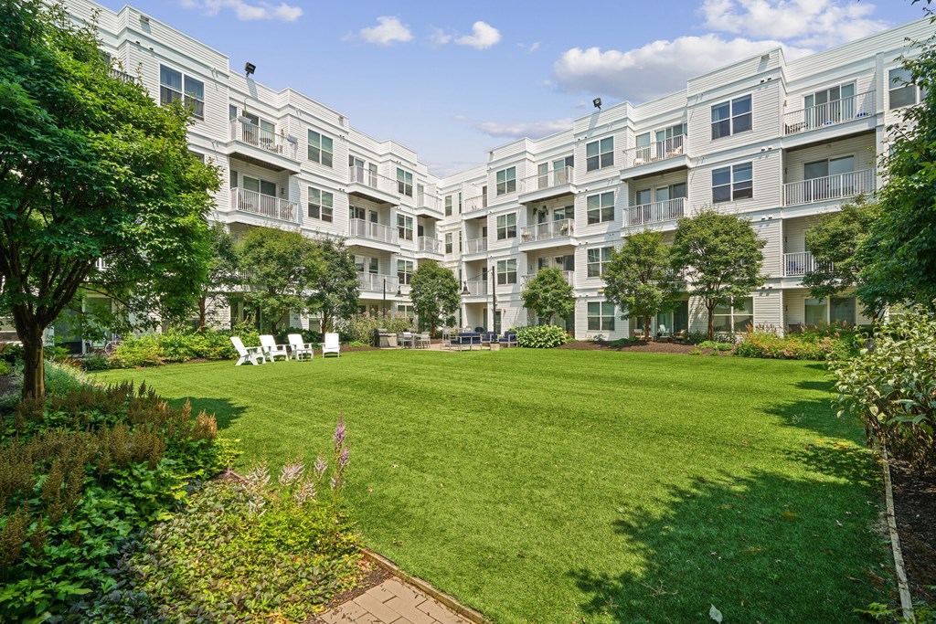 a large green lawn in the middle of an apartment complex