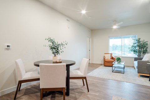 A dining room with a table and chairs.