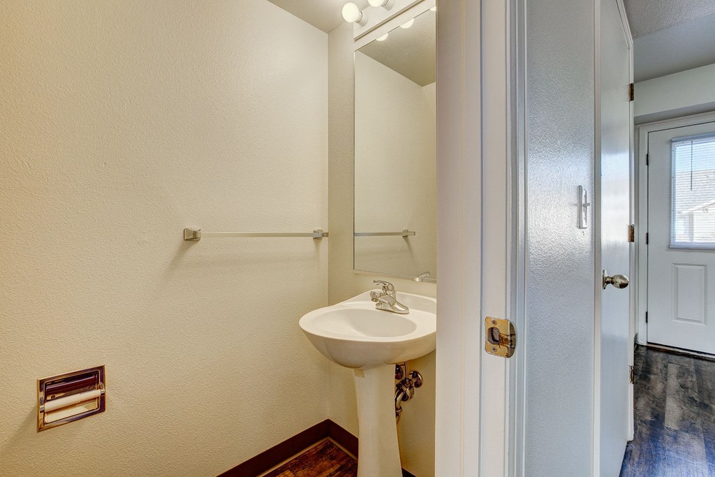A white sink in a small bathroom.