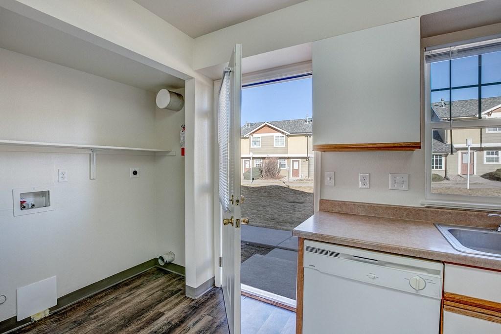 A view of a kitchen with a dishwasher and a sink.