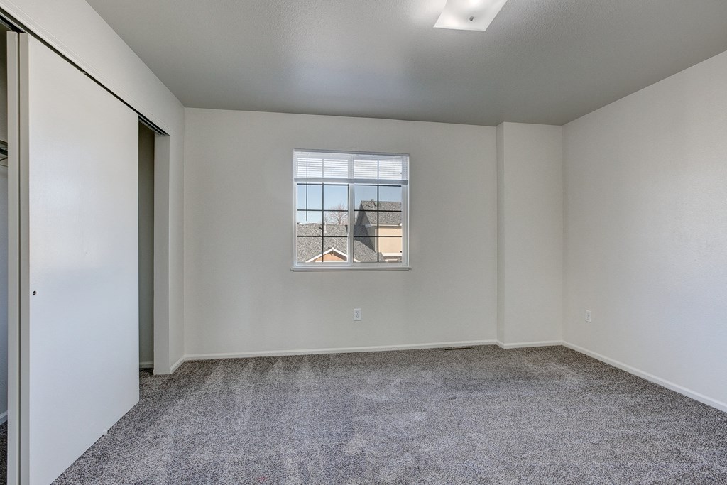 A room with a window and a door.