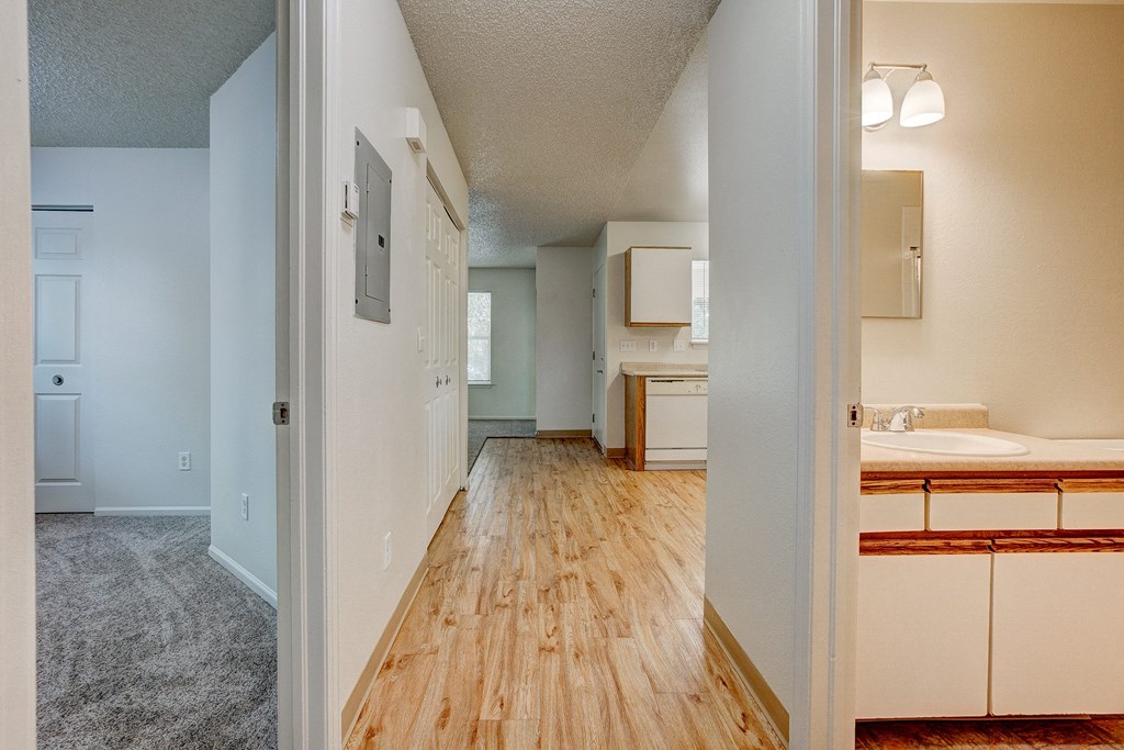 the view of a spacious living room and bathroom from the entrance of a house