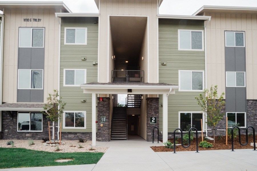 A building with a green and beige exterior and a number 2 on the front.