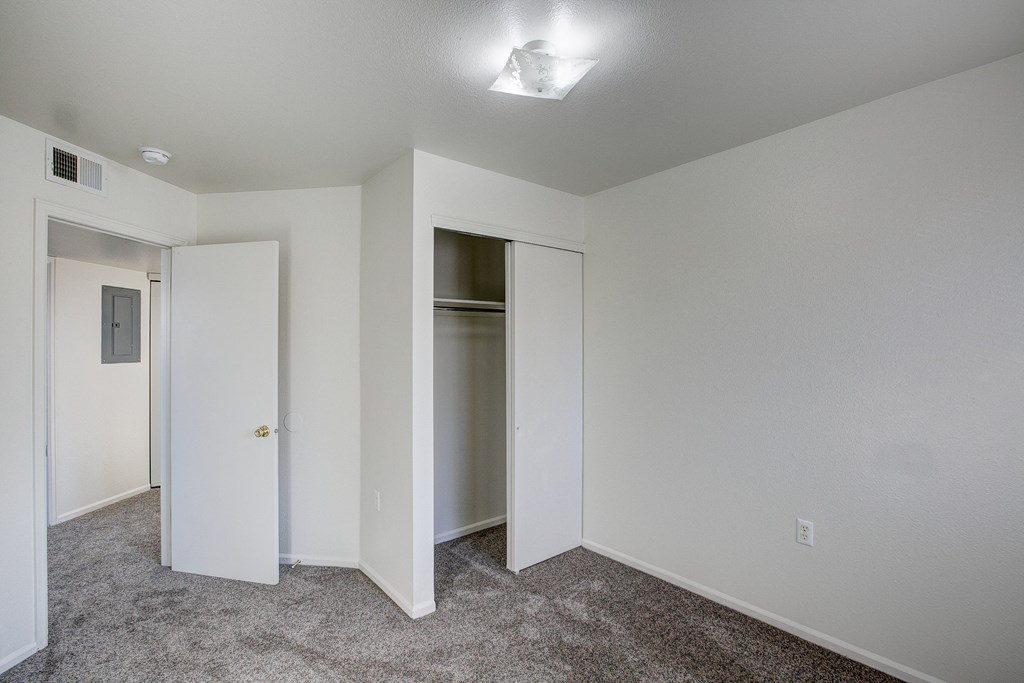 A room with a carpeted floor and a ceiling light.