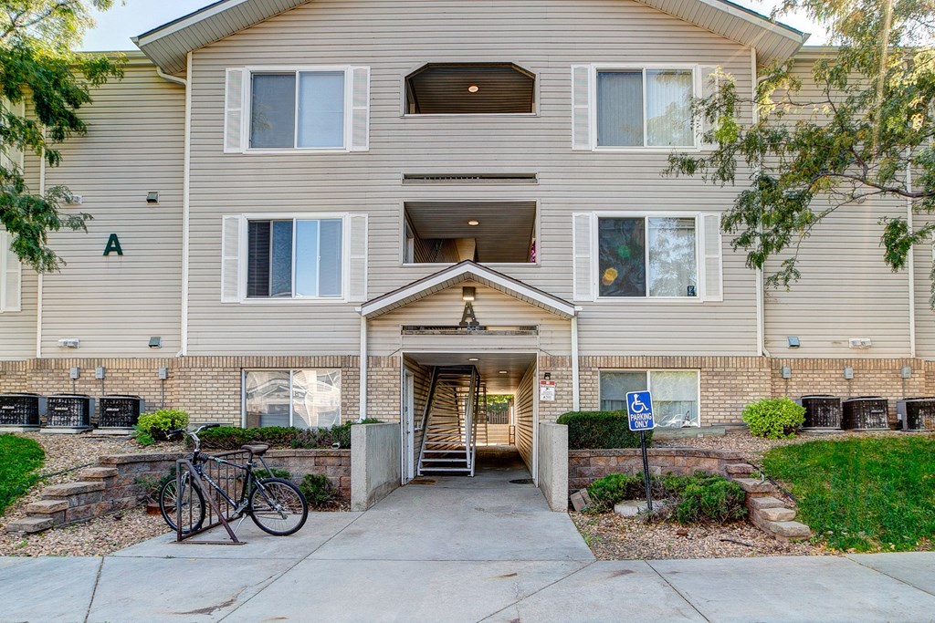 the front of an apartment building with two bikes parked outside