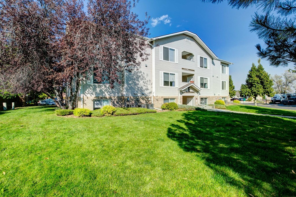 a large white house with a yard in front of it