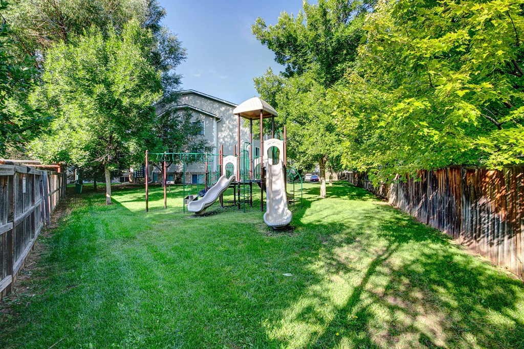 a backyard with a playground and a swing set