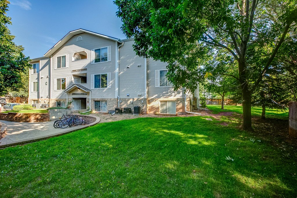 a blue house with a yard and trees