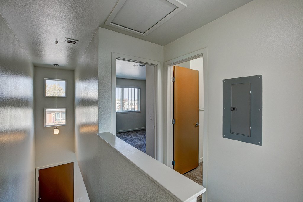 the view of a living room from a hallway with an open door