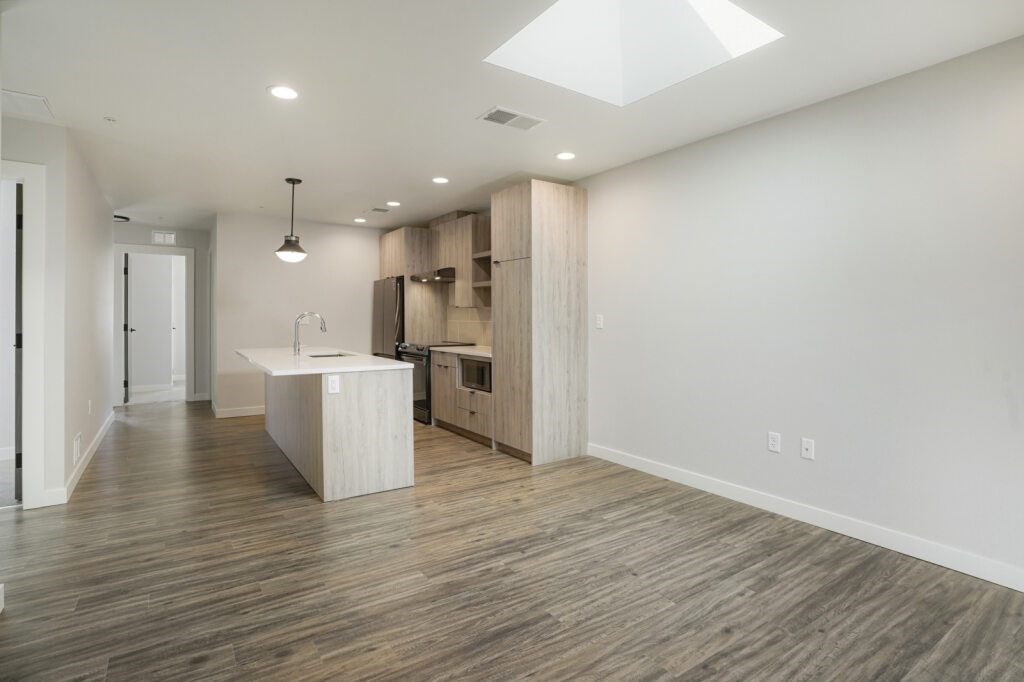 A spacious kitchen with wooden floors and a skylight at The Avenue Lofts Golden Apartments, Golden
