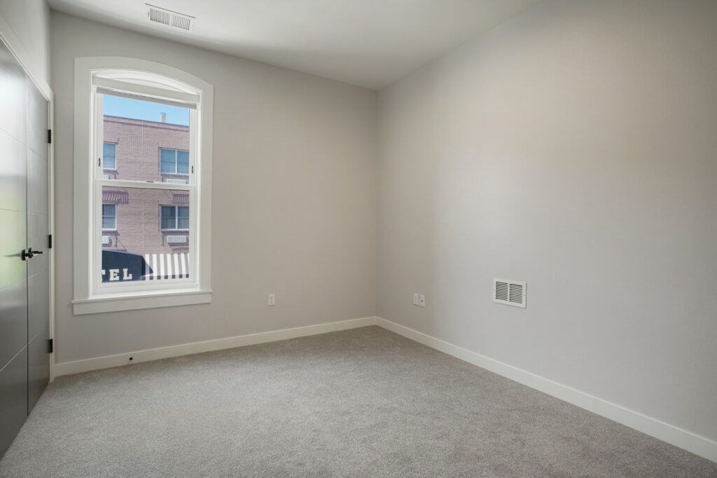 A room with a window and a door at The Avenue Lofts Golden Apartments, Colorado, 80401