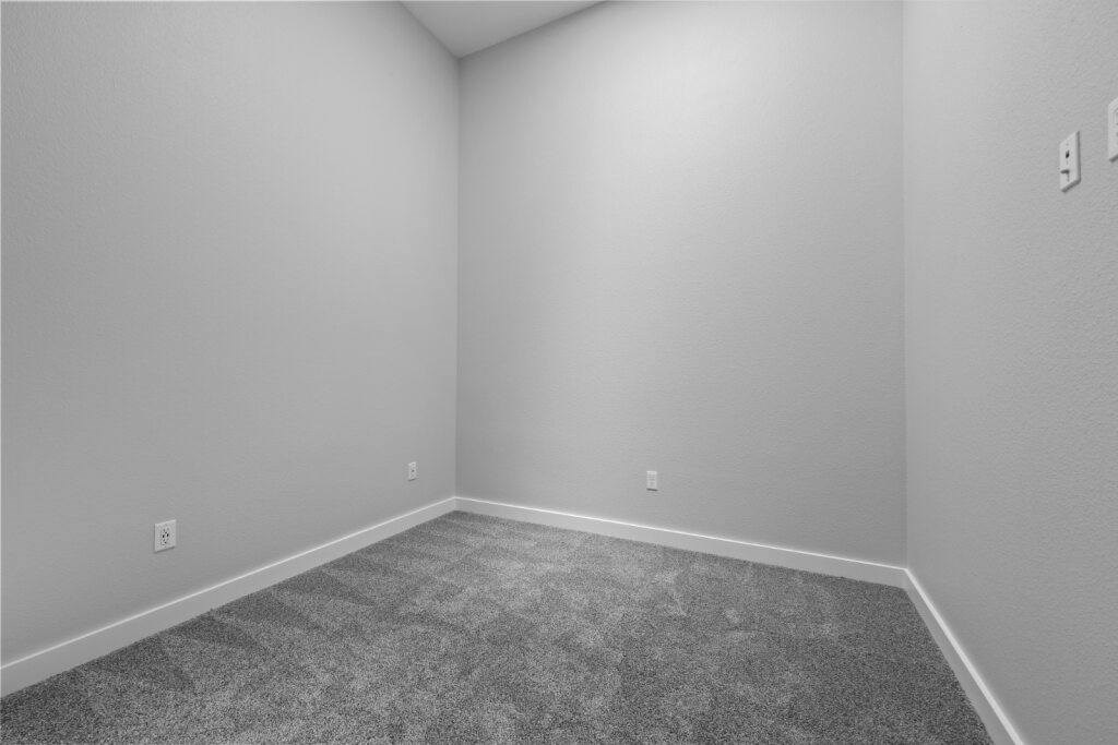A room with grey carpet and white walls at The Avenue Lofts Golden Apartments, Golden 80401