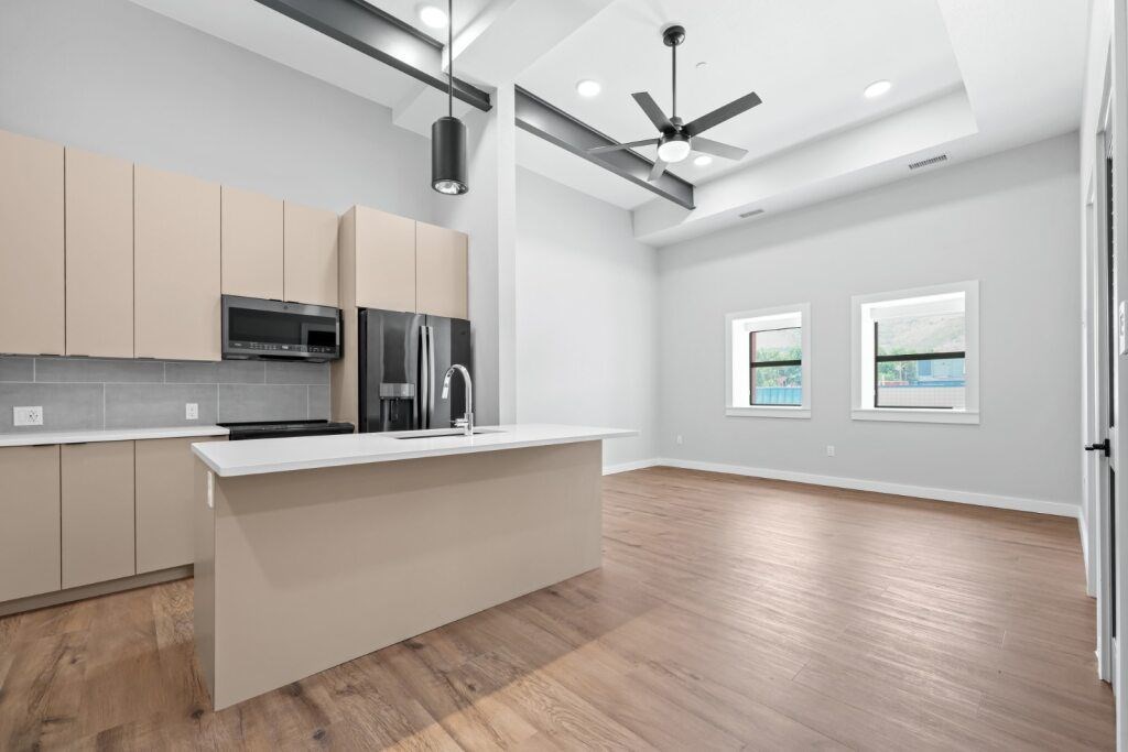A kitchen with wooden floors and a countertop with a microwave and coffee maker at The Avenue Lofts Golden Apartments, Golden
