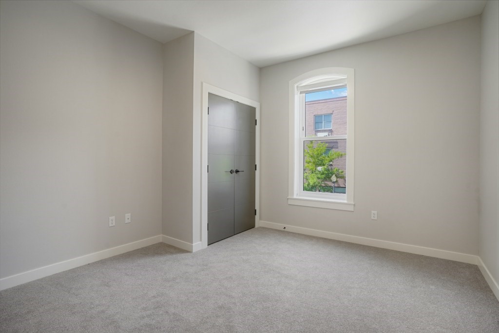 A room with a carpeted floor and a window at The Avenue Lofts Golden Apartments, Golden, Colorado