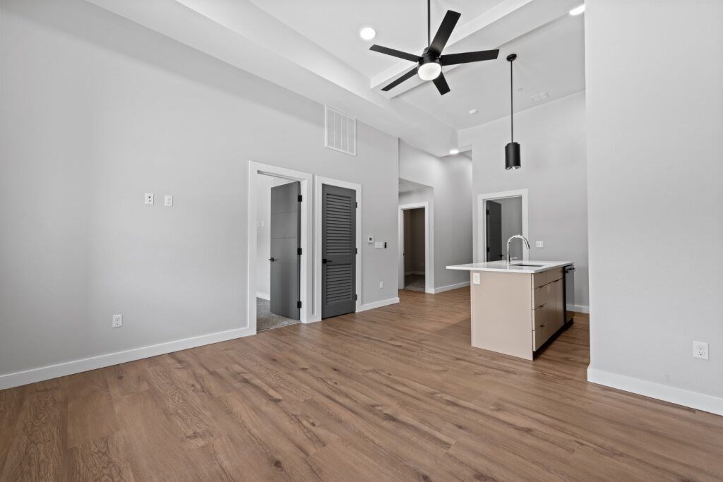 A room with a ceiling fan and a desk at The Avenue Lofts Golden Apartments, Golden, CO, 80401