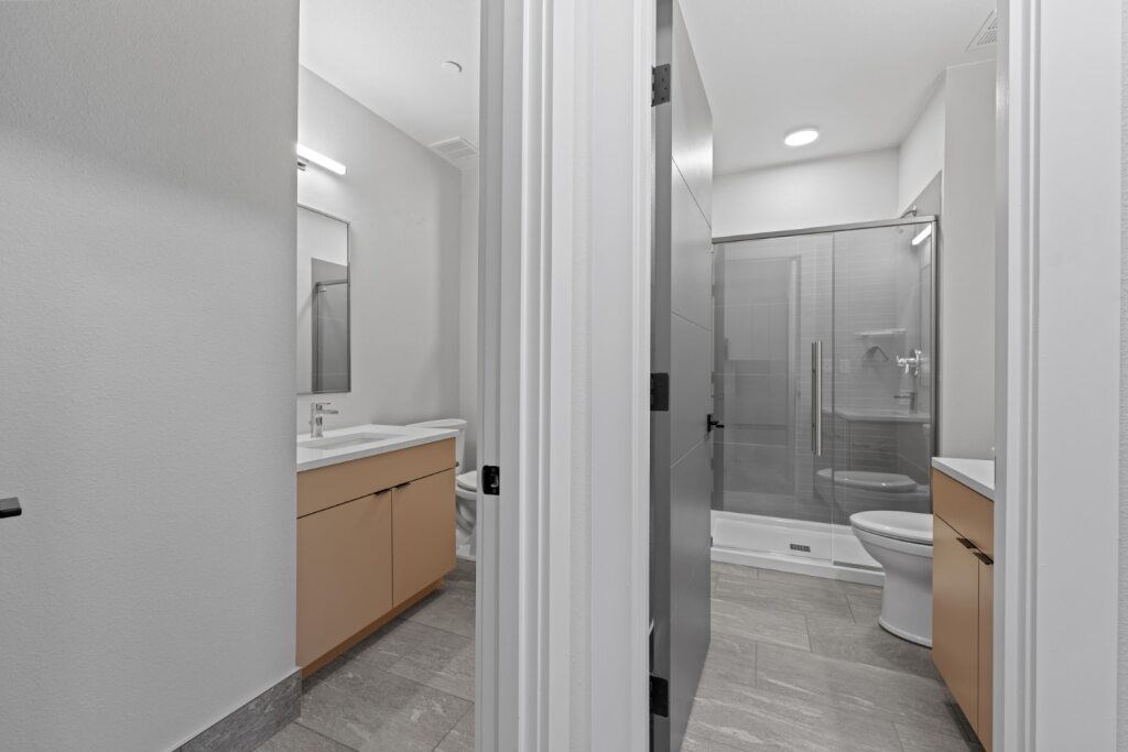 A bathroom with a walk-in shower and a toilet at The Avenue Lofts Golden Apartments, Golden