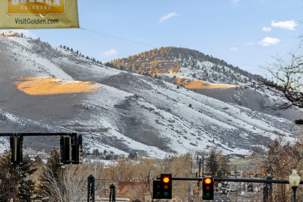 A mountain with a sign that says VisitGolden.com at The Avenue Lofts Golden Apartments, Golden 80401