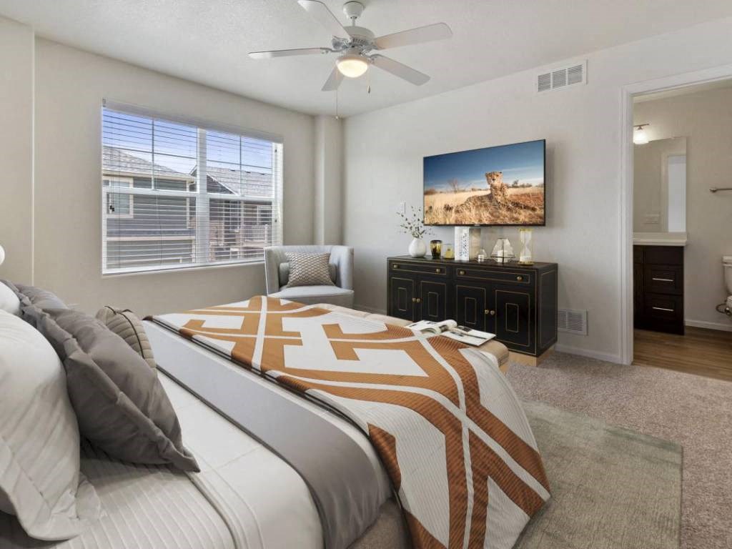 Bedroom With TV at Belle Creek Commons, Henderson, CO
