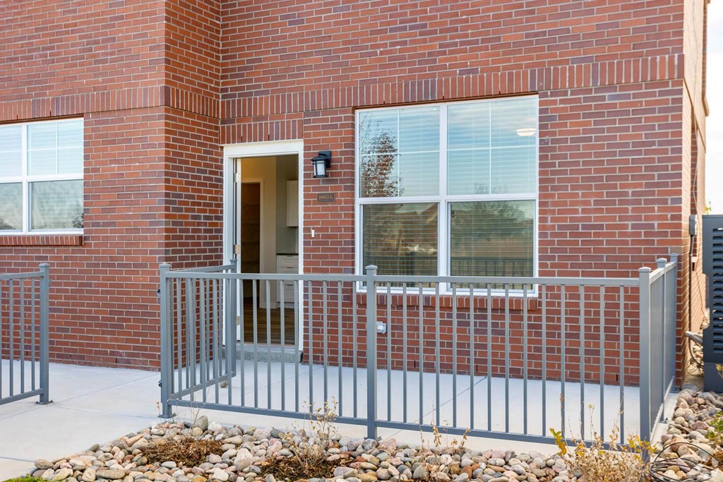 red brick building with patio at Brownstones at Palisade Park Townhomes, Broomfield, CO