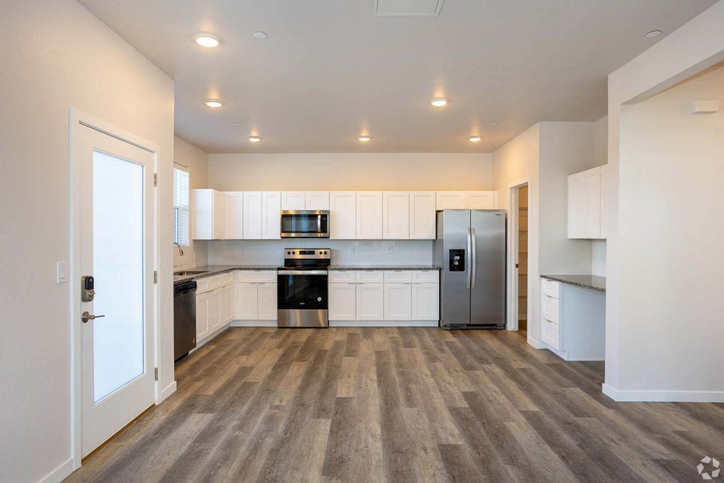 large kitchen area with plank wood floor at Palisade Park Townhomes, Broomfield Colorado