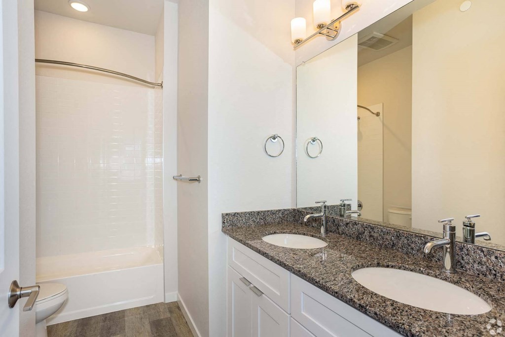 double vanity bathroom with white shower at Brownstones at Palisade Park Townhomes, Broomfield, CO