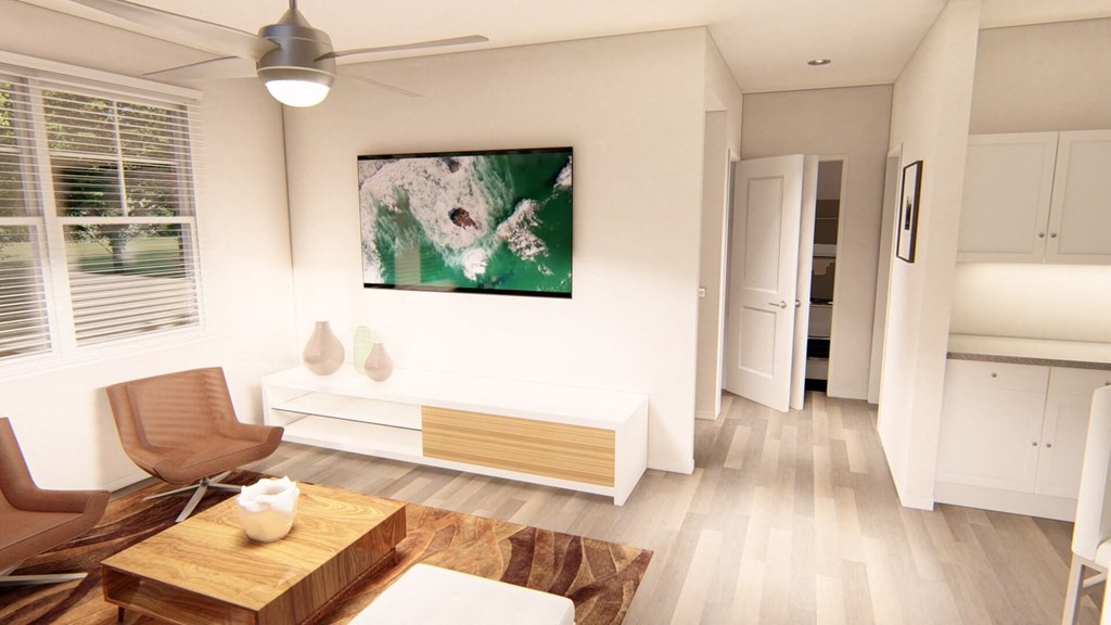 a living room with hardwood floors and white walls at Brownstones at Palisade Park, Broomfield