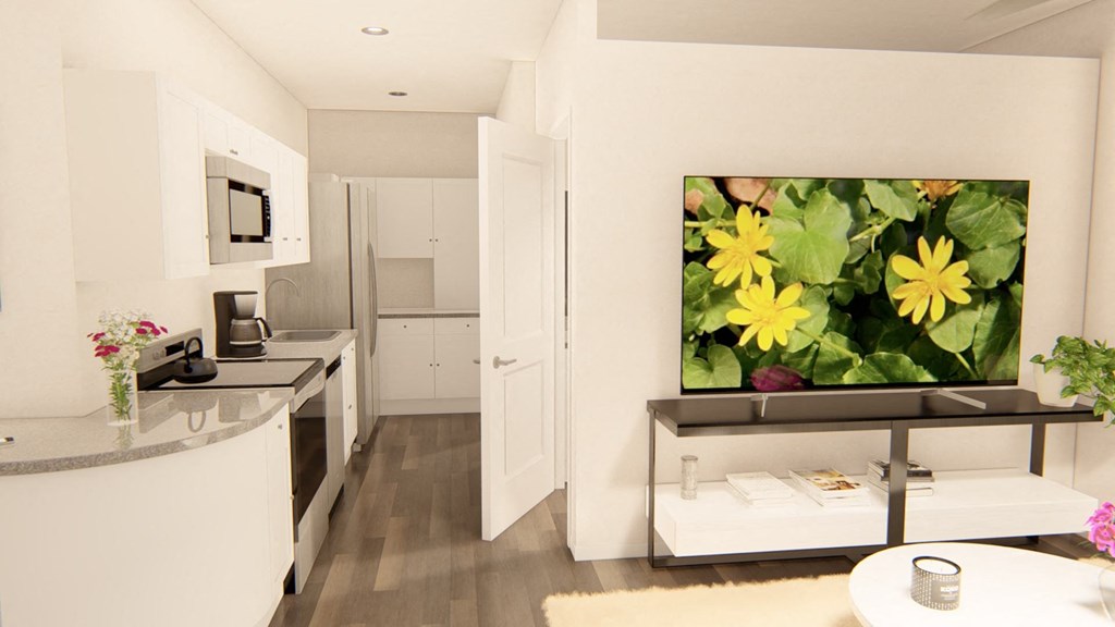 a kitchen with white cabinets and a large painting of yellow flowers on the wall at Brownstones at Palisade Park, Colorado, 80023