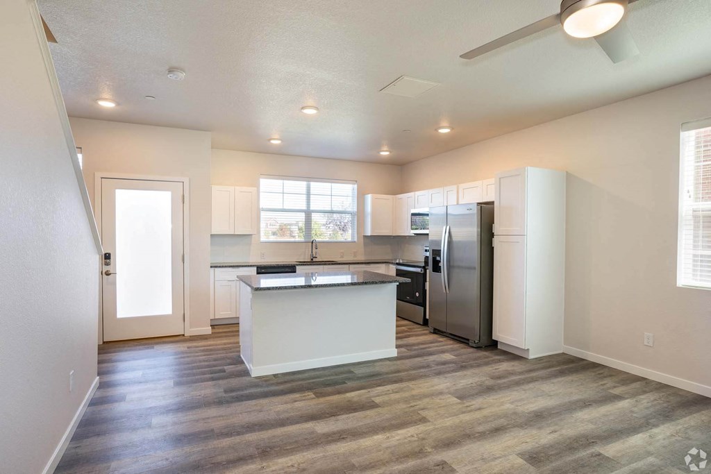 open living room with granite kitchen island at Palisade Park Townhomes, Broomfield Colorado