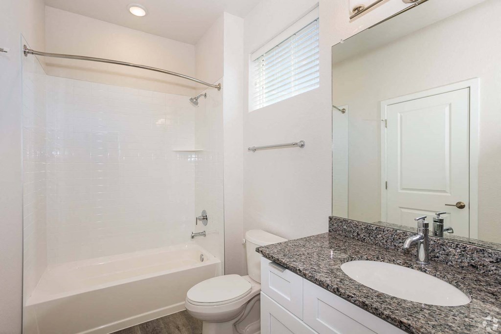bathroom with white tub and grey sink at Brownstones at Palisade Park Townhomes, Broomfield, CO